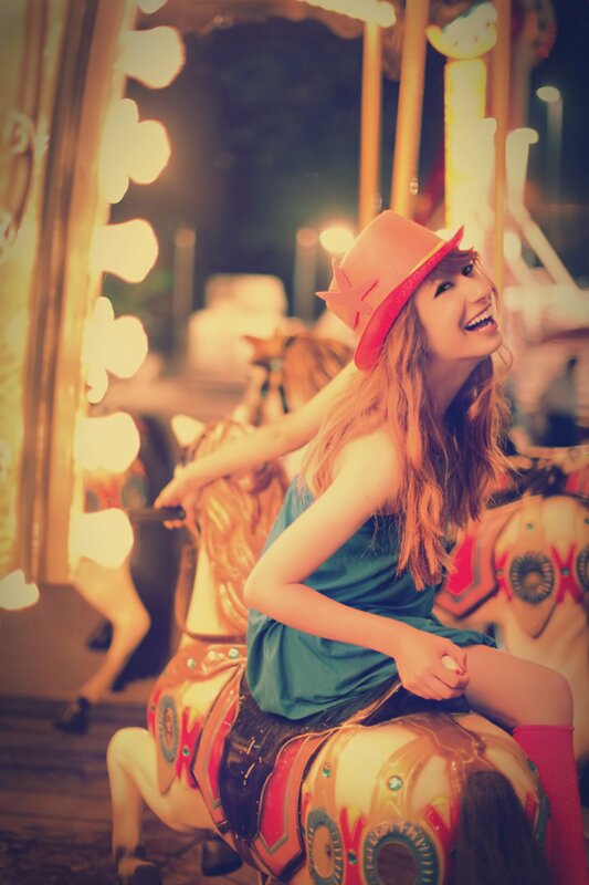 Woman on a carousel at night