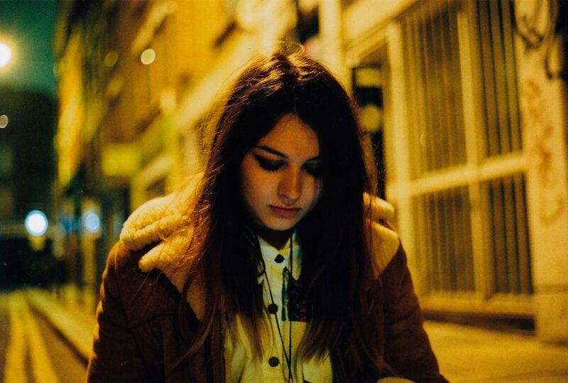 woman on a city street at night