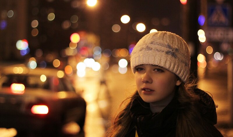 woman on a city street at night