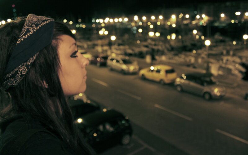 woman on a city street at night