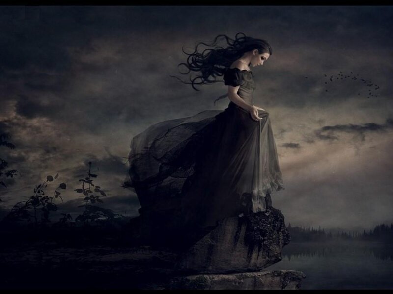 woman on a cliff at dusk