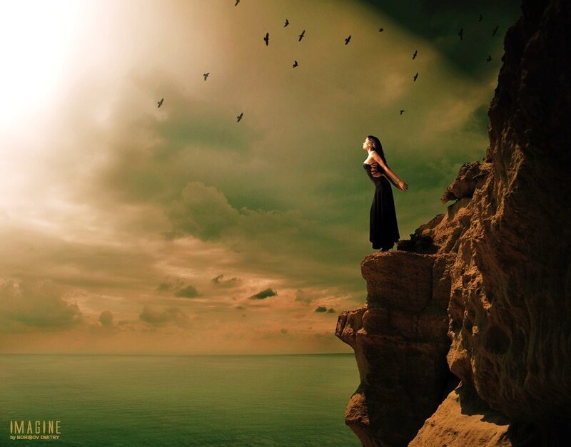 Woman on a cliff at sunset