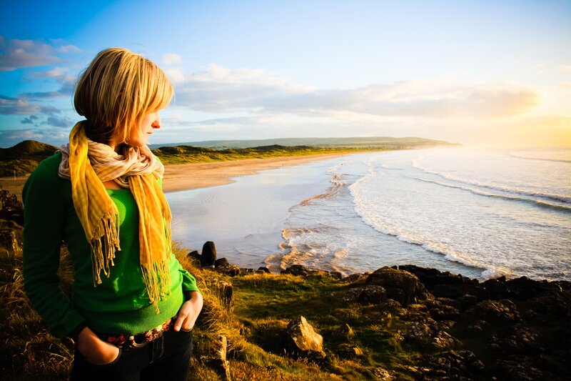 Woman on a cliff overlooking the sea