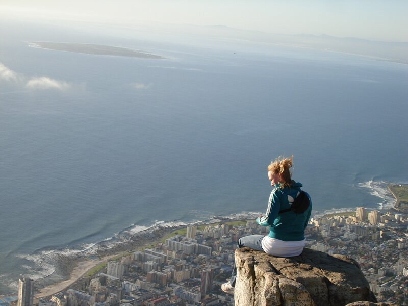 Woman on a cliff overlooking the sea