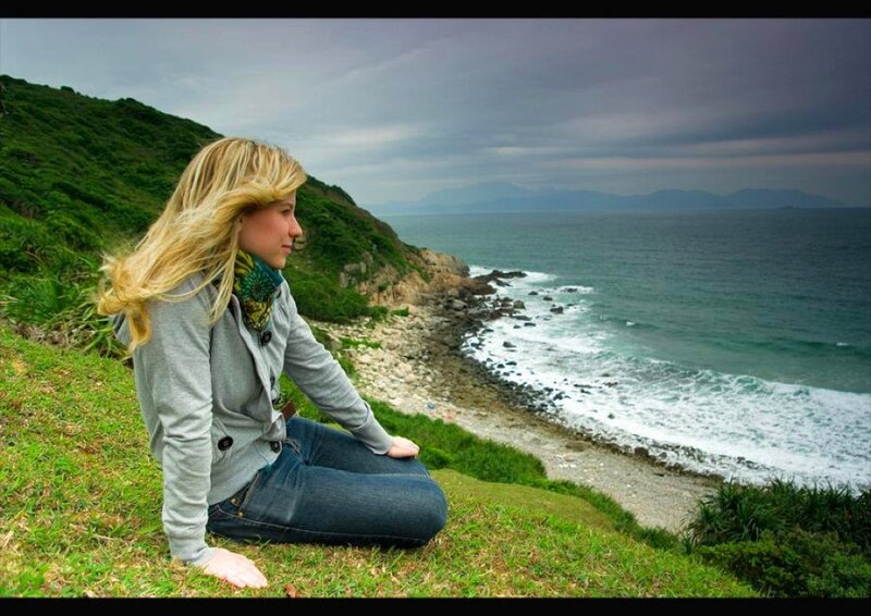 Woman on a cliff overlooking the sea