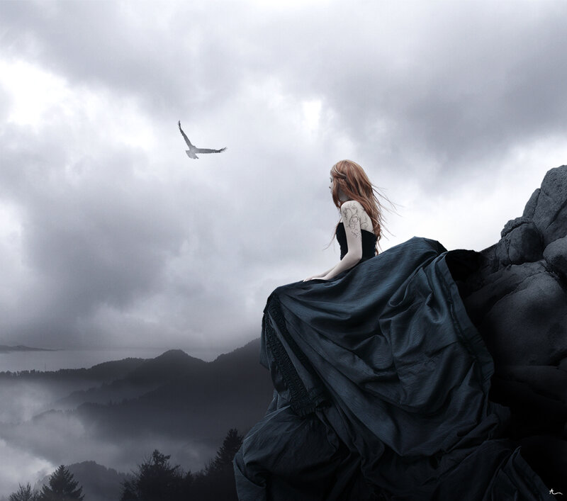 Woman on a cliff with a bird
