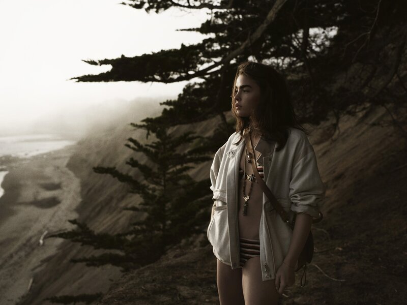 Woman on a cliffside beach
