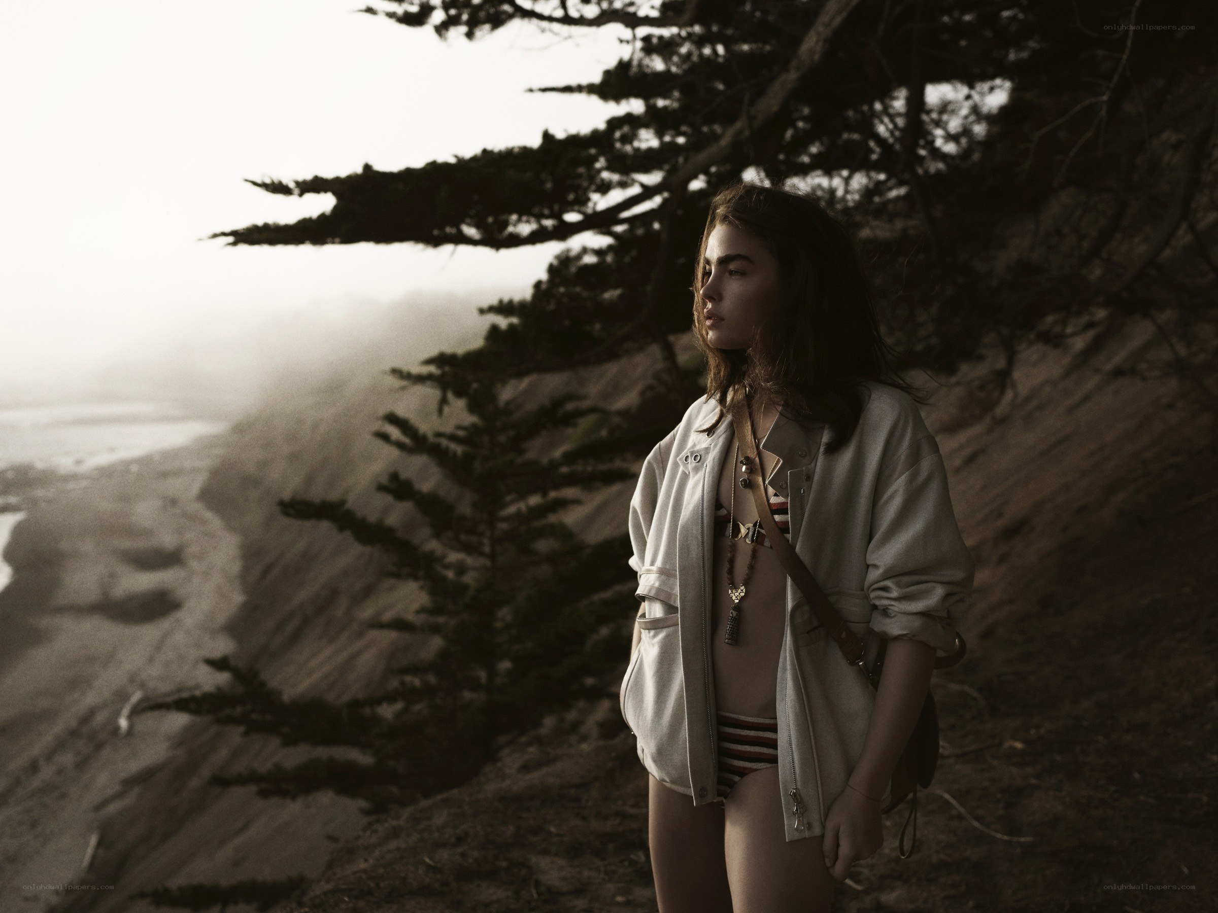 Woman on a cliffside beach