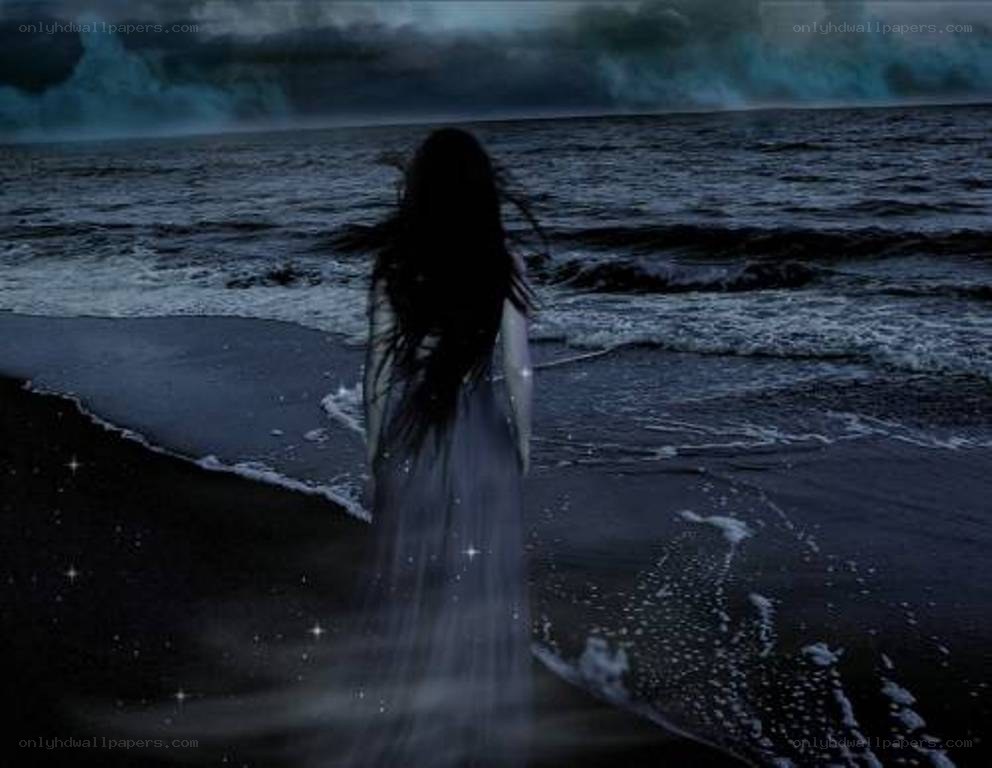 woman on a dark beach