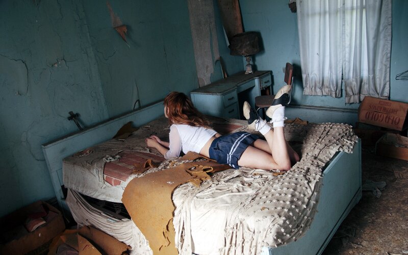 woman on a dilapidated bed