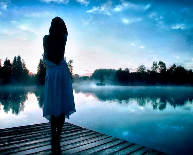 Woman on a dock at dawn