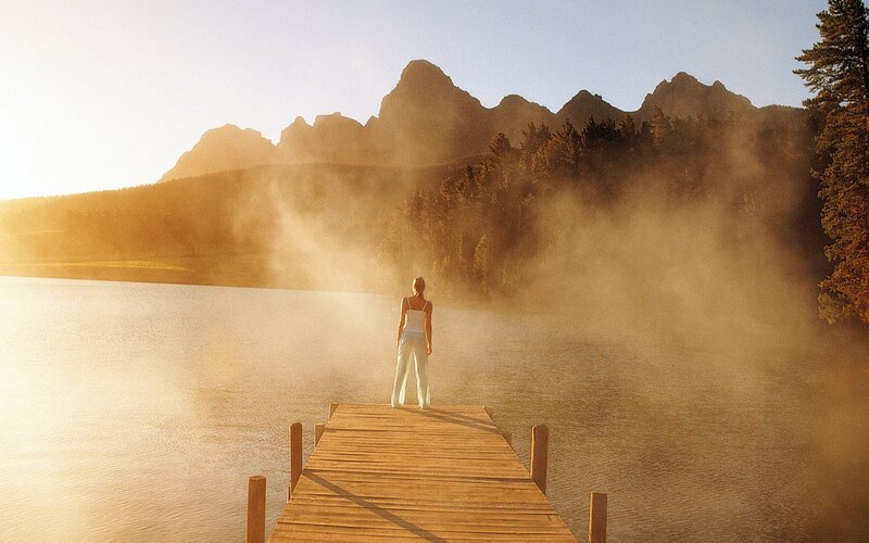 Woman on a dock at sunrise
