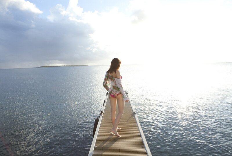 Woman on a dock at sunset