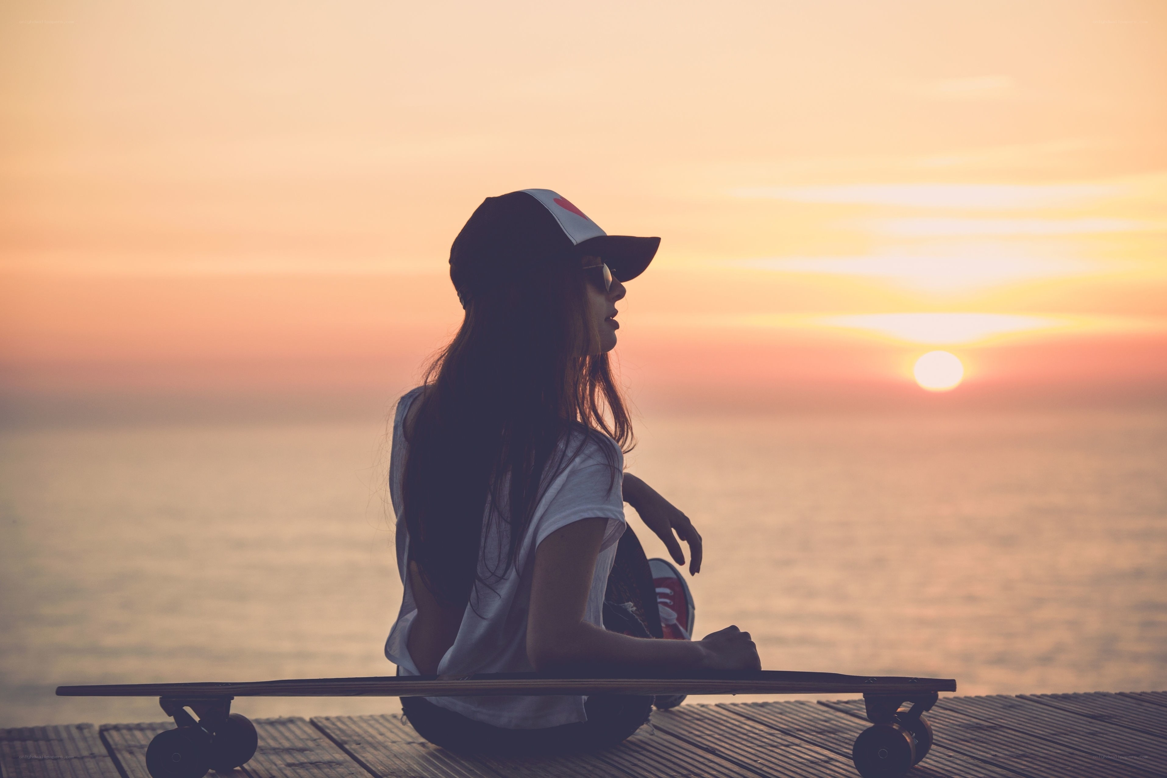 Woman on a dock at sunset