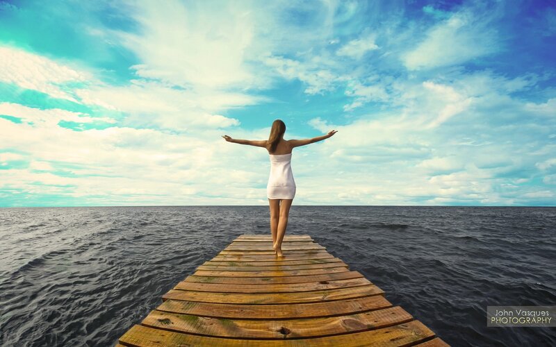 Woman on a dock with open arms