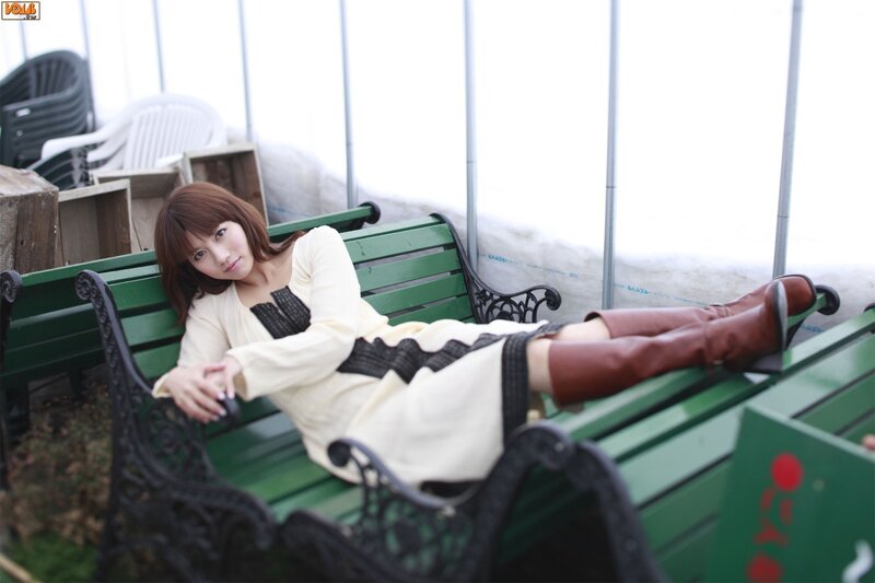 Woman on a green bench