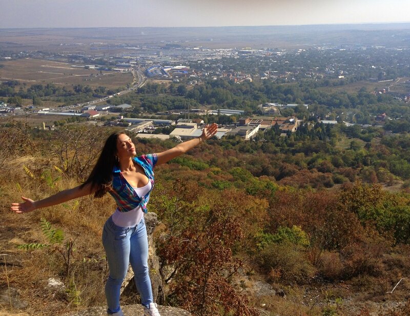 Woman on a hill overlooking a city
