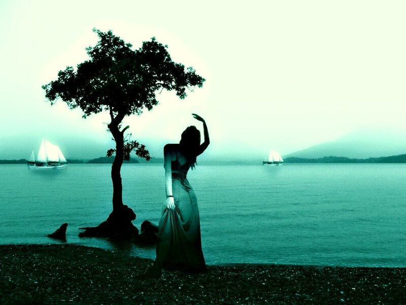 woman on a lakeshore at dusk