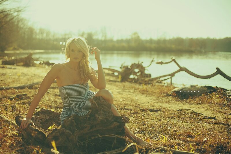 Woman on a log by the river