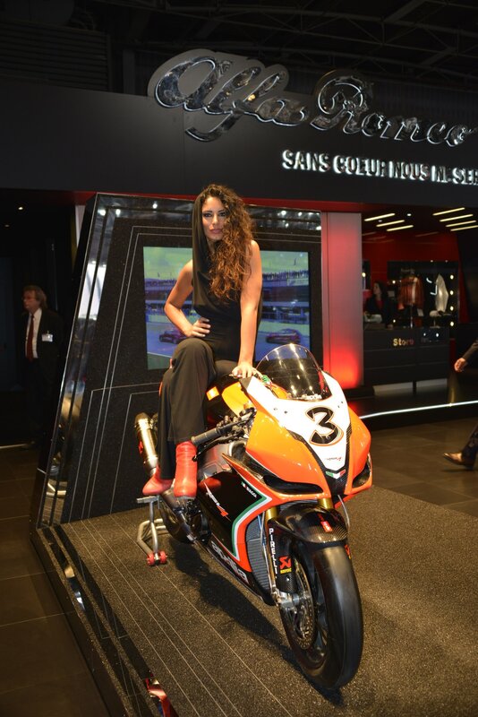 Woman on a motorcycle at an auto show