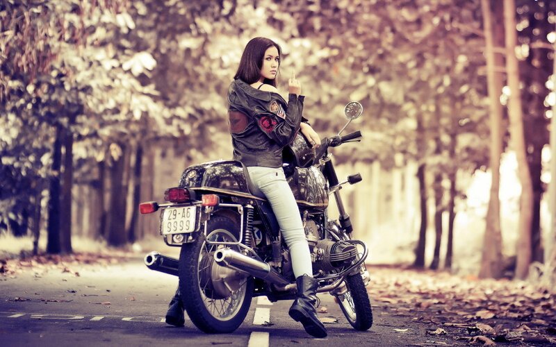 Woman on a motorcycle in autumn