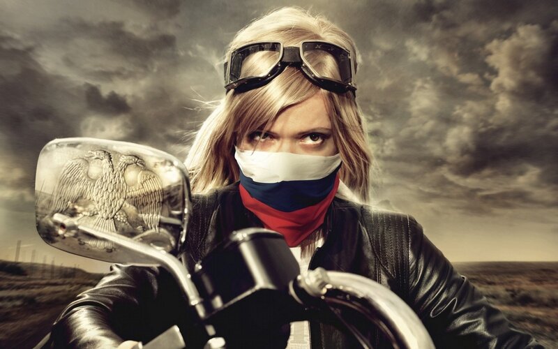 Woman on a motorcycle with Russian flag