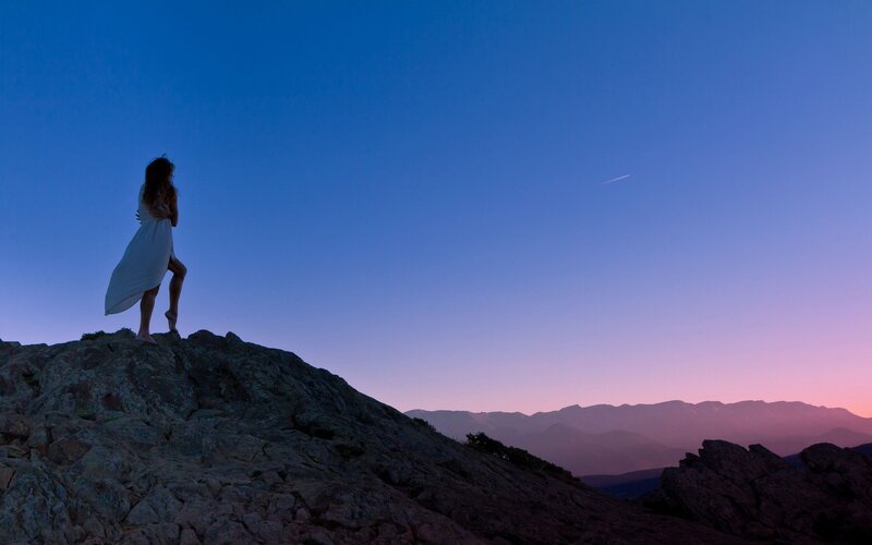 Woman on a mountain at dusk