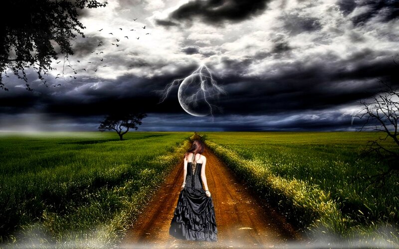 Woman on a path under stormy sky
