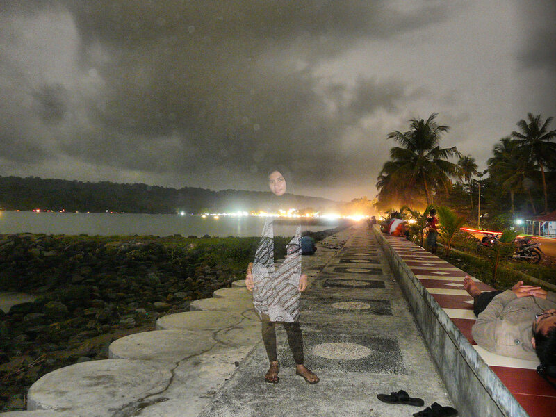 Woman on a pier at night