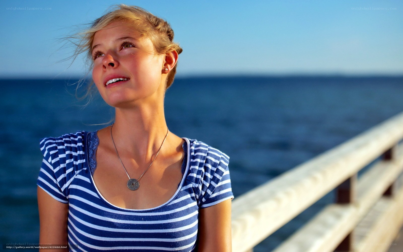 woman on a pier at sunset
