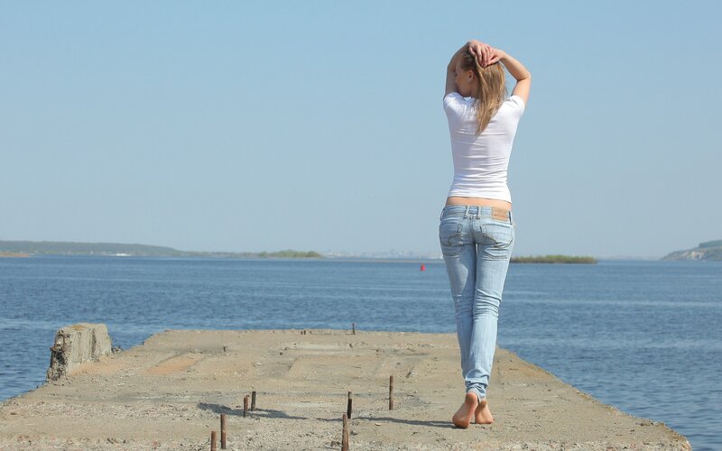 Woman on a pier by the water