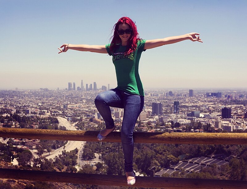 Woman on a railing overlooking city
