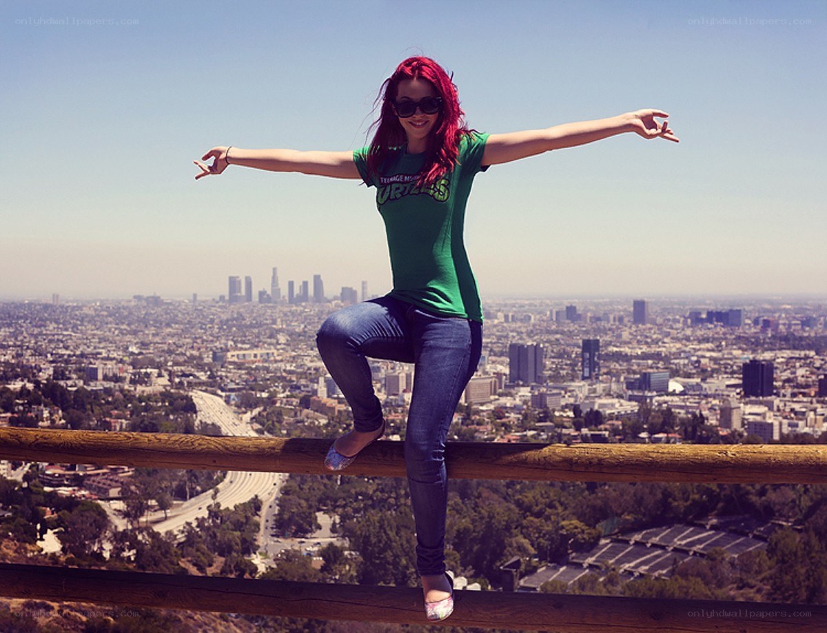 Woman on a railing overlooking city