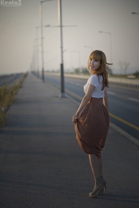 Woman on a road at sunset