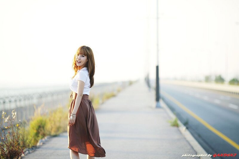 woman on a road at sunset