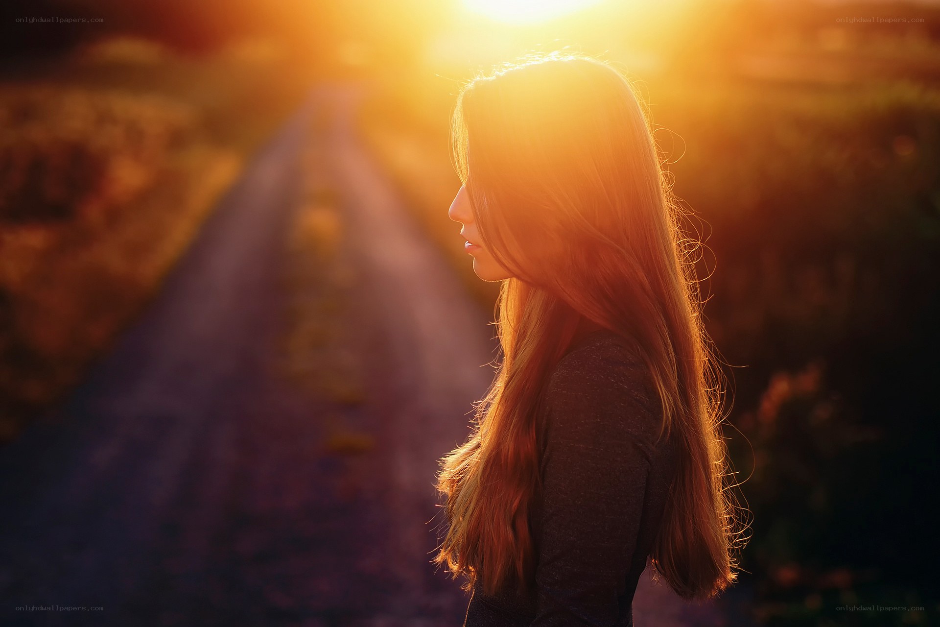 woman on a road at sunset