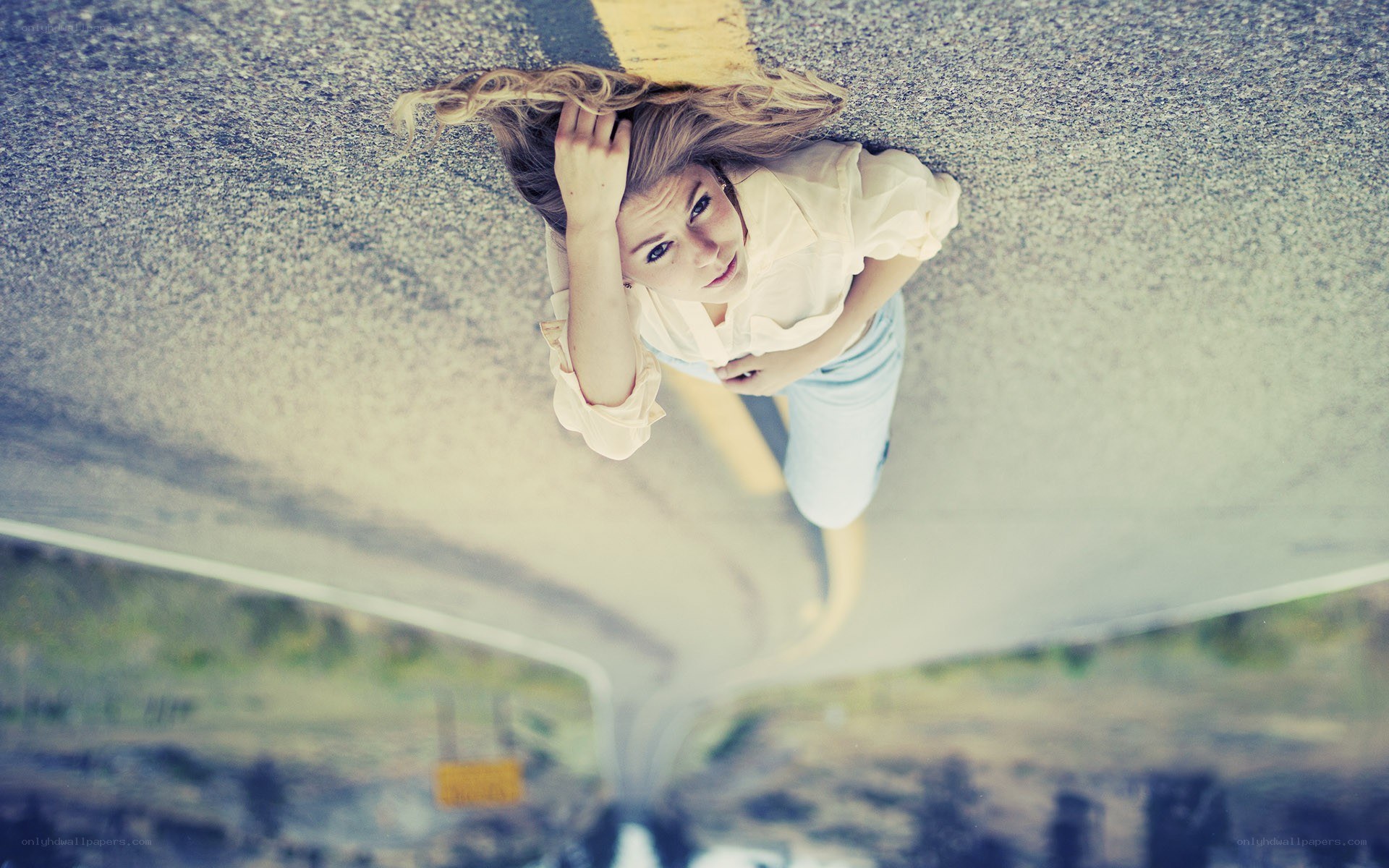 woman on a road looking up