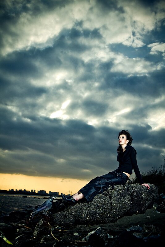 Woman on a rock at sunset