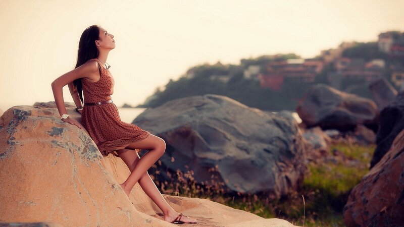Woman on a rock at sunset