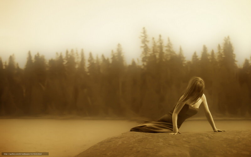 woman on a rock by the lake