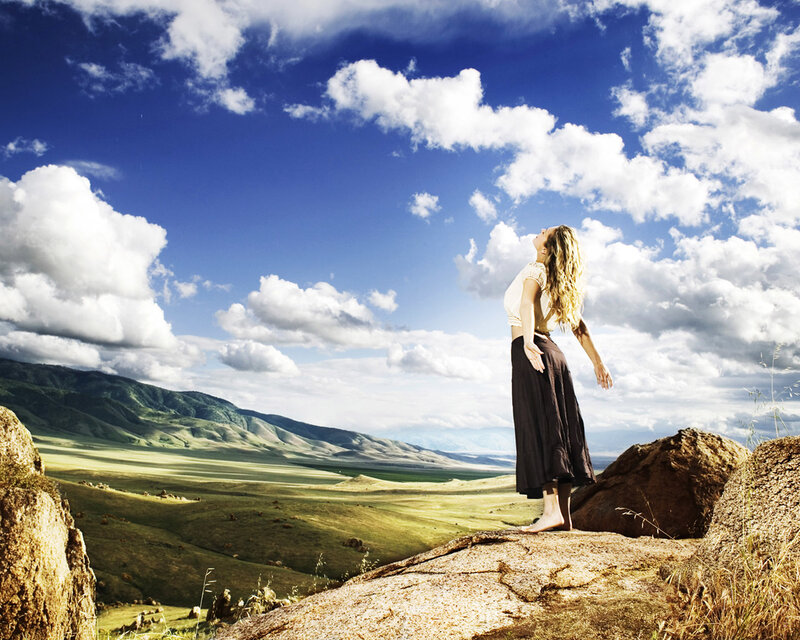 Woman on a rock overlooking valley