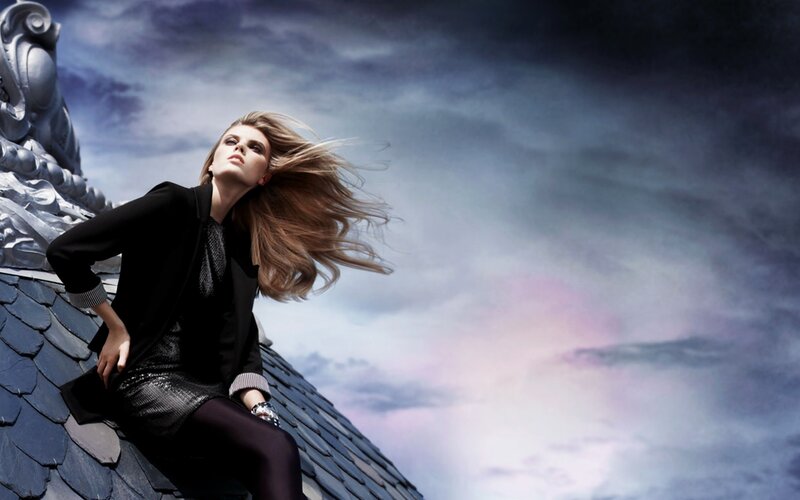 woman on a roof with wind-blown hair
