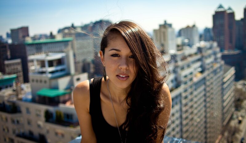 woman on a rooftop with city view