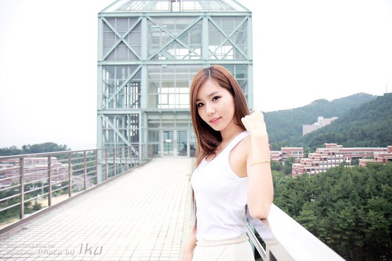 Woman on a rooftop with glass building