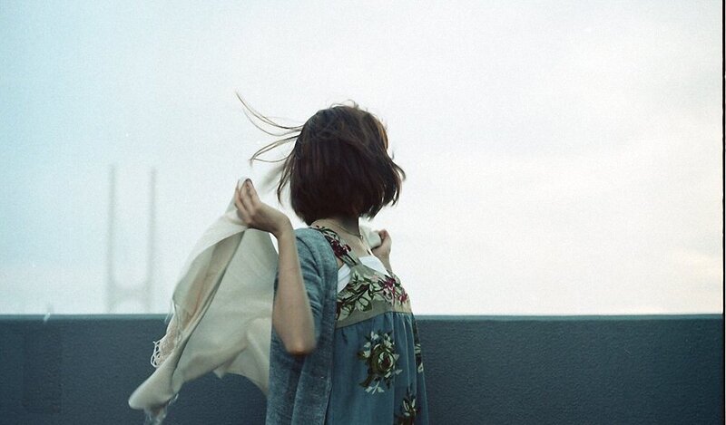 woman on a rooftop with scarf