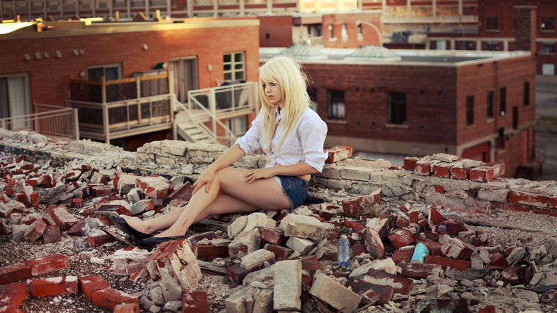 Woman on a rubble-strewn rooftop
