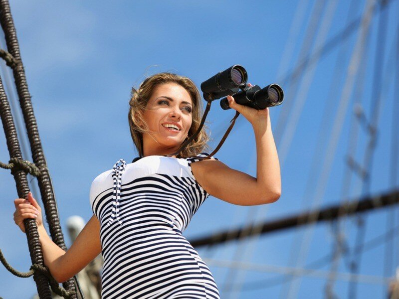 woman on a ship with binoculars