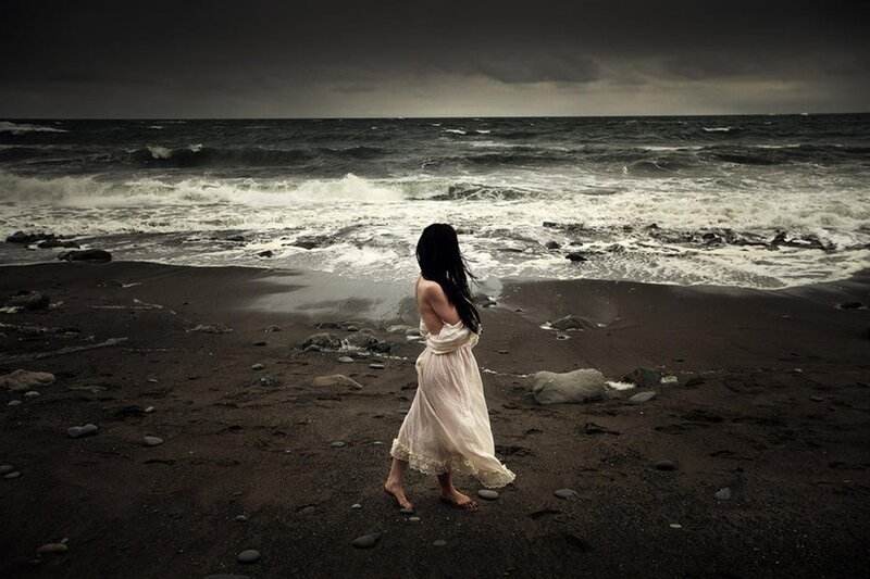 Woman on a stormy beach