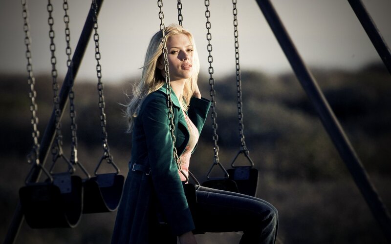 Woman on a swing at dusk