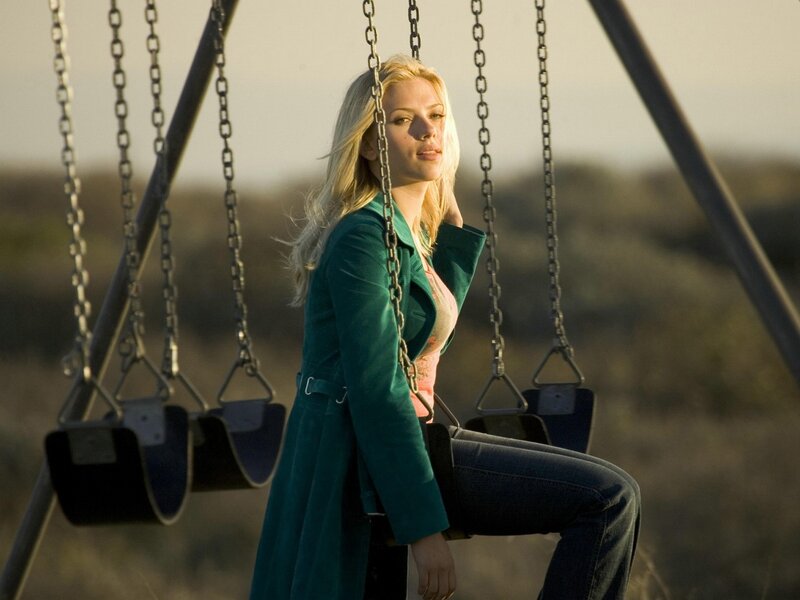 Woman on a swing at sunset